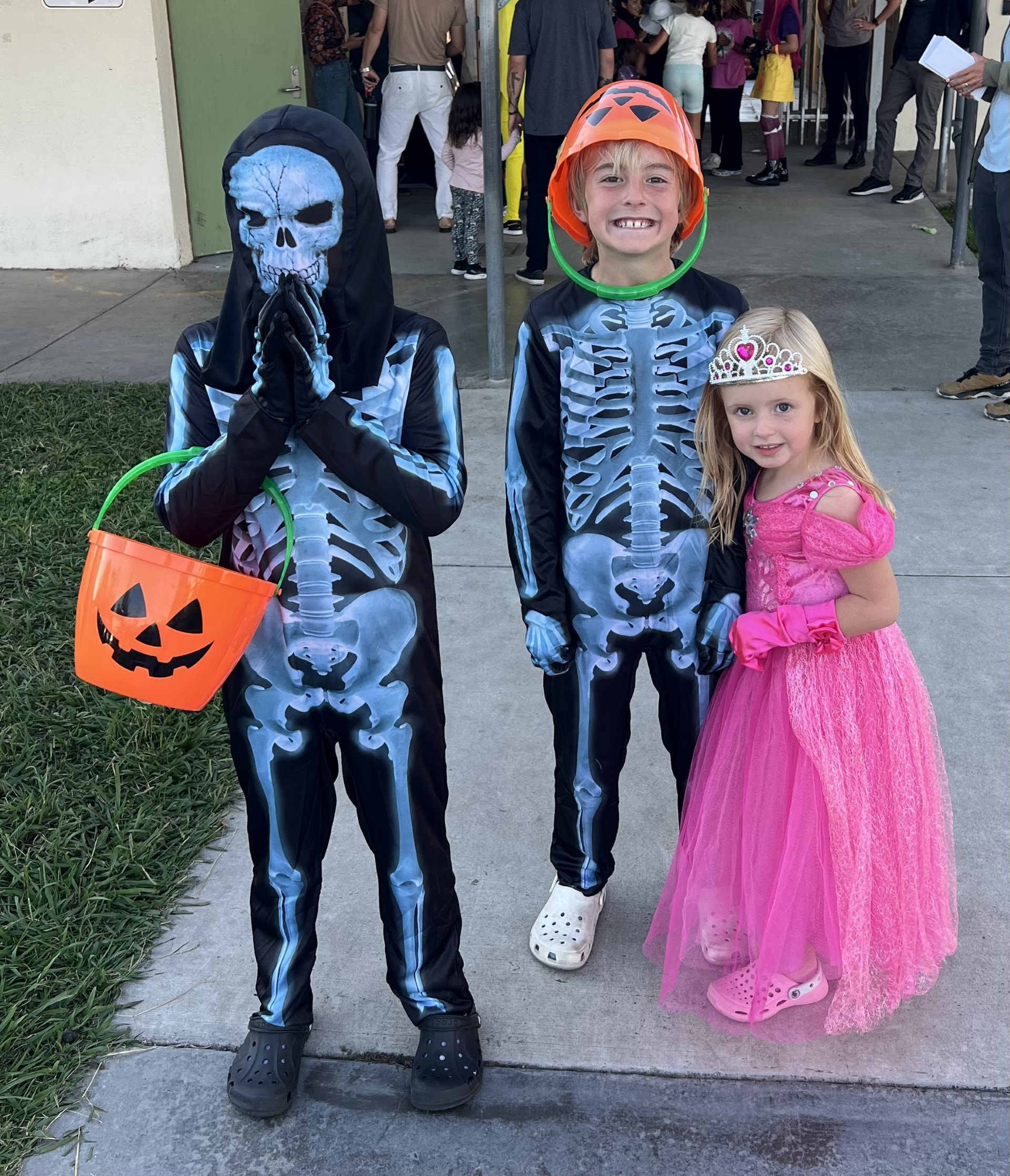 Three children dressed in Halloween costumes
